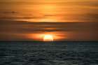 Sun sets amid light clouds in the Gulf of Mexico. Art Print